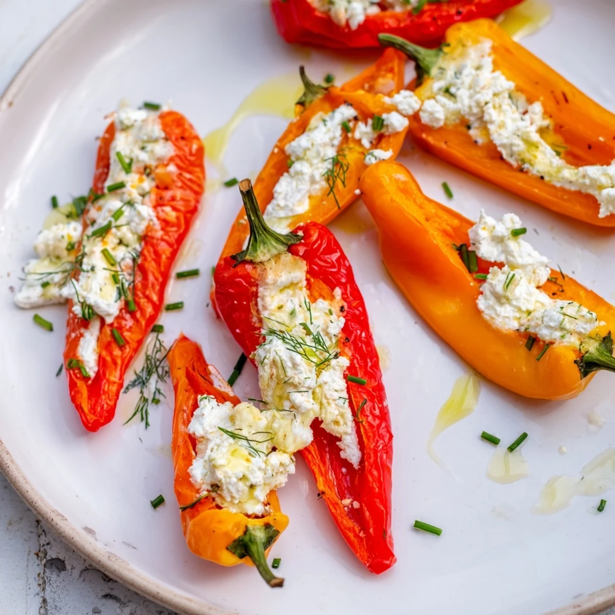 Fresh, vibrant mini bell peppers filled with creamy feta, perfect for a flavorful appetizer.