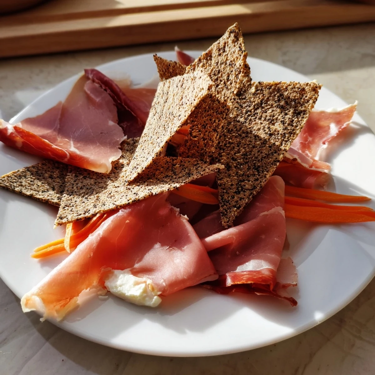 Paper Crane appetizer, featuring artfully folded prosciutto and bresaola with crisp crackers, ready to eat.