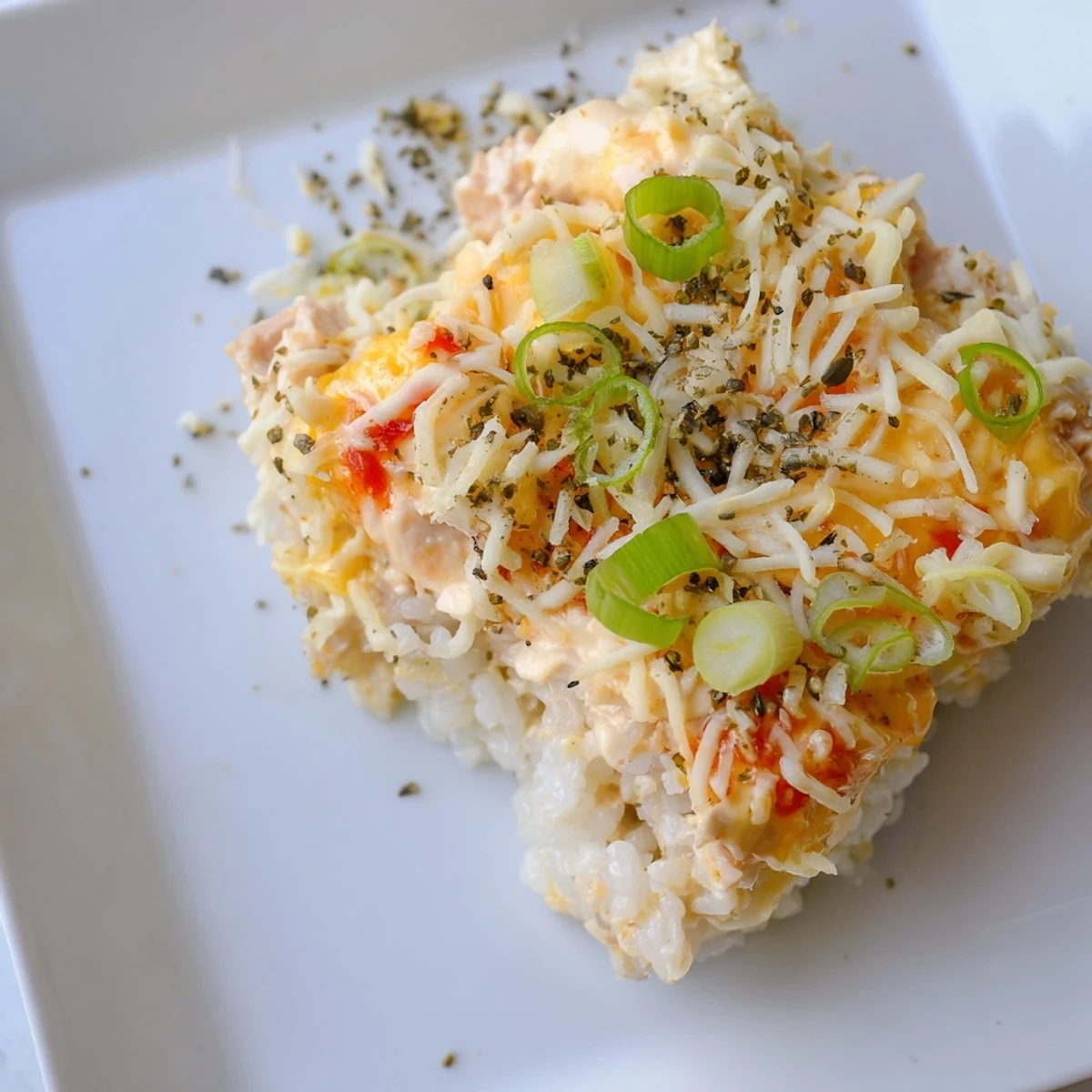 Golden, bubbly Chicken Sushi Bake, a savory casserole with flaky chicken and creamy filling, ready to serve.