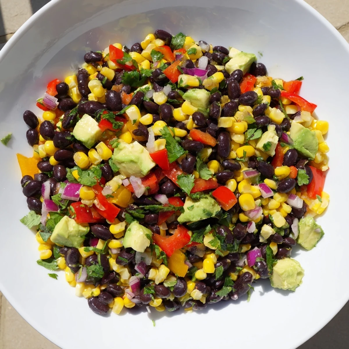 Close-up of a flavorful Southwest Black Bean Salad, perfect served alongside crunchy tortilla chips.