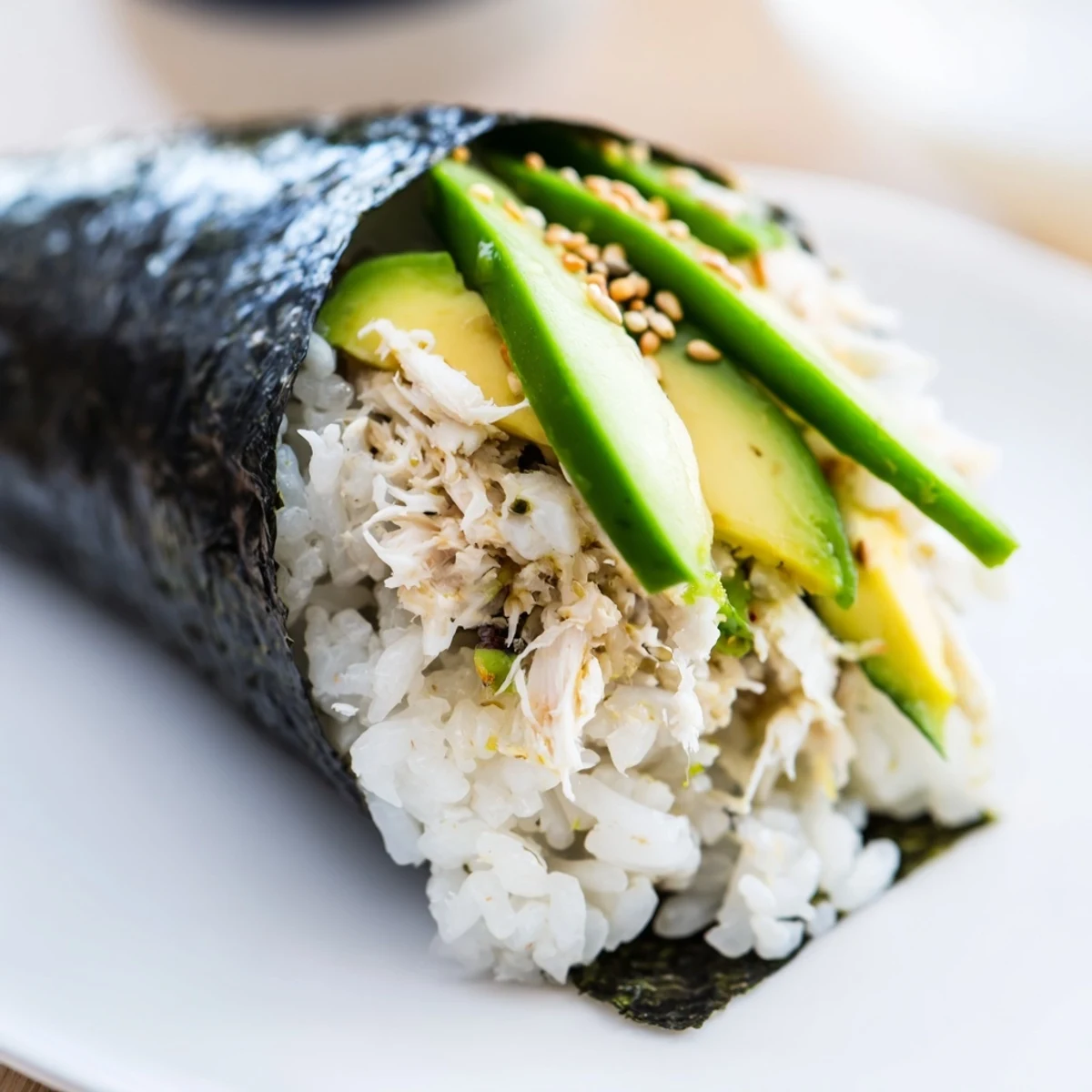 A close-up of two fresh Sushi Rice Hand Rolls, showcasing the creamy avocado and crisp cucumber nestled in nori.