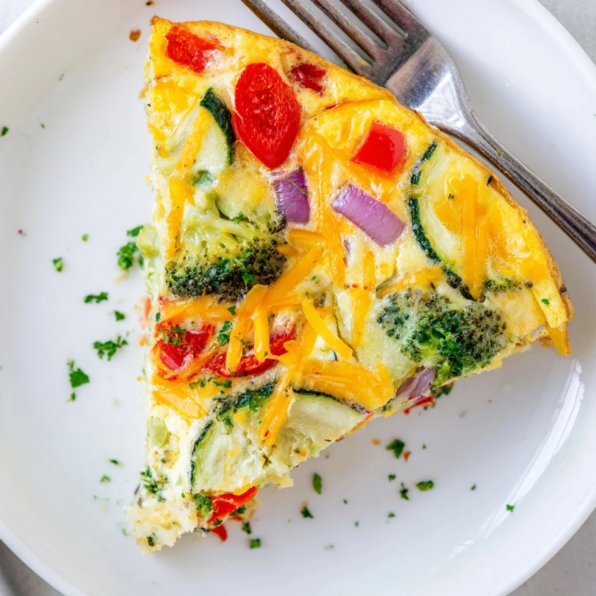 Colorful Italian vegetable frittata with broccoli and onions, baked to perfection and ready for a vegetarian brunch or dinner.