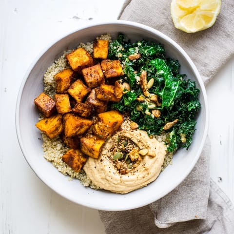 Vibrant Light Coastal Bowl featuring tender sweet potatoes and fresh kale, drizzled with zesty dressing.