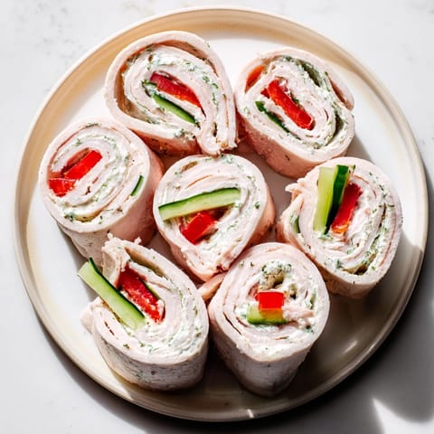 Freshly made turkey roll-ups with a colorful veggie filling, ready to serve as a tasty snack.