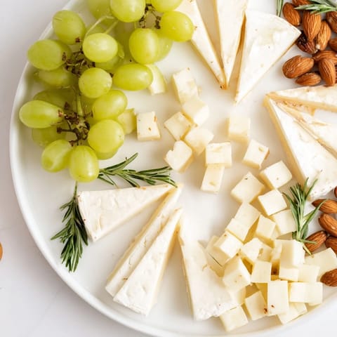 Beautifully arranged Book Club Pairing Platter: cheeses, meats, olives, and fruit for appetizers.
