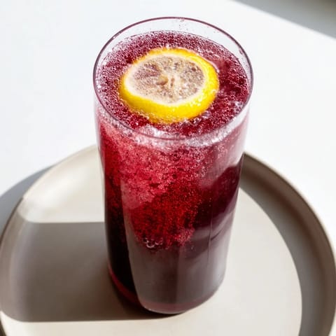 The deep red color of a homemade Sleepy Girl Mocktail, ready to soothe and refresh you.