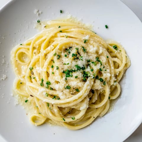 Creamy Miso Butter Pasta, glistening with Parmesan, suggests a comforting and aromatic dinner.