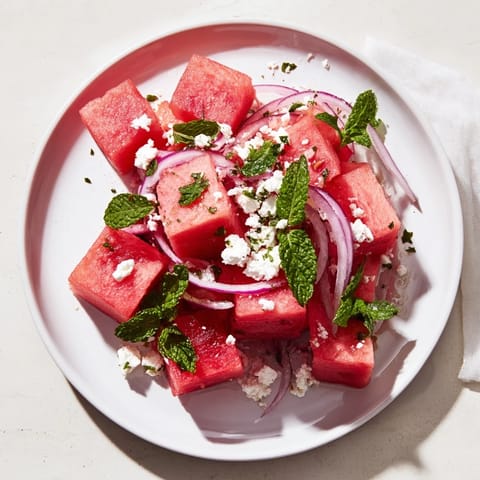 Vibrant watermelon feta salad showcases sweet watermelon cubes with crumbled feta and fresh mint.