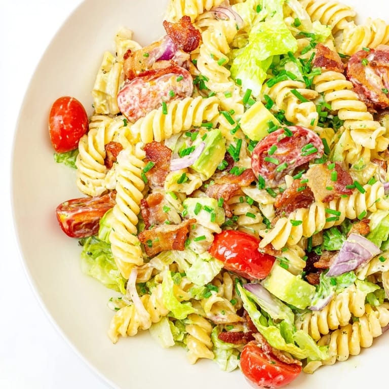 This BLT Pasta Salad showcases colorful tomatoes, bacon bits, and pasta in a delicious, chilled dish.