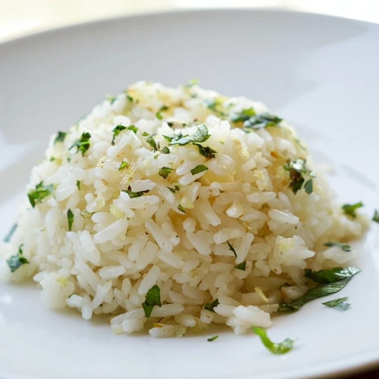 Garlic-infused jasmine rice garnished with scallions, paired with grilled tofu for a vibrant, vegan-friendly meal.
