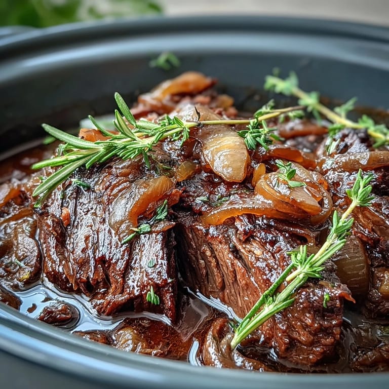 Melt-in-your-mouth beef topped with caramelized onions and fresh parsley garnish.